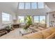 Bright living room with fireplace, plush sofas, and large windows offering views of the beach at 1209 N Atlantic Ave, New Smyrna Beach, FL 32169