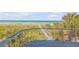 Stunning ocean views from a deck overlooking a wooden walkway to the beach at 1209 N Atlantic Ave, New Smyrna Beach, FL 32169