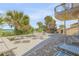 Expansive outdoor patio with dining and lounge seating, enhanced by tropical landscaping and ocean breezes at 1209 N Atlantic Ave, New Smyrna Beach, FL 32169
