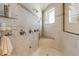 Spacious shower with a built-in seat, multiple shower heads, and decorative tile accents at 1209 N Atlantic Ave, New Smyrna Beach, FL 32169