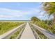 Inviting beachside escape with a charming walkway leading to the ocean at 1209 N Atlantic Ave, New Smyrna Beach, FL 32169