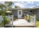 Outdoor deck filled with lush plants and a white door at 1284 Vanderbilt Dr, Ormond Beach, FL 32174