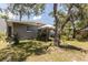 Backyard featuring lush grass, white tent, and a gray house exterior at 1284 Vanderbilt Dr, Ormond Beach, FL 32174