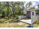 View of a spacious backyard and deck filled with lush plants at 1284 Vanderbilt Dr, Ormond Beach, FL 32174