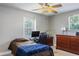 Cozy bedroom with natural light, ceiling fan, study desk, and well-maintained hardwood dresser at 1284 Vanderbilt Dr, Ormond Beach, FL 32174