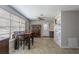 Bright dining area features a wood table, chairs, large windows, and access to the kitchen at 1284 Vanderbilt Dr, Ormond Beach, FL 32174