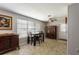 Dining area with a wooden table and chairs, large window, and vintage furnishings at 1284 Vanderbilt Dr, Ormond Beach, FL 32174