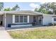 Charming single-story home with a gray exterior, decorative block accent, and covered porch at 1284 Vanderbilt Dr, Ormond Beach, FL 32174