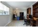 Bright home office with an artist's easel, large windows, and custom built-in shelving at 1284 Vanderbilt Dr, Ormond Beach, FL 32174