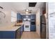 Kitchen with blue cabinets, tiled floor, stainless appliances, and a decorative ceiling at 1284 Vanderbilt Dr, Ormond Beach, FL 32174