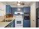 Cozy kitchen with blue cabinets, ample counter space, and white appliances at 1284 Vanderbilt Dr, Ormond Beach, FL 32174