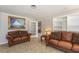Comfortable living room with leather sofas, decorative artwork, and ample seating at 1284 Vanderbilt Dr, Ormond Beach, FL 32174