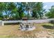 View of the backyard showing the fire pit, wooden fence and surrounding trees at 1326 13Th St, Orange City, FL 32763