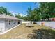 Spacious backyard featuring a firepit, patio and new fence and lush landscaping at 1326 13Th St, Orange City, FL 32763