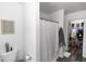 Clean bathroom with a toilet, shower with curtain, and walk-in closet with shelving at 1326 13Th St, Orange City, FL 32763