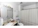 Well-lit bathroom with granite countertop, a framed mirror, and shower-tub combination at 1326 13Th St, Orange City, FL 32763