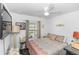 Cozy bedroom featuring a ceiling fan, window, and a soft patterned bedspread at 1326 13Th St, Orange City, FL 32763