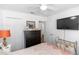 This bedroom features a ceiling fan, dresser with mirror, and a wall-mounted television at 1326 13Th St, Orange City, FL 32763