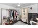 Bedroom with a ceiling fan, large closet with shelving and a cushioned accent chair at 1326 13Th St, Orange City, FL 32763
