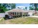 Charming single-story home with a well-manicured front lawn and a welcoming front porch area with seating at 1326 13Th St, Orange City, FL 32763