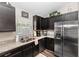 Stylish kitchen featuring dark cabinets, granite countertops, and modern appliances at 1326 13Th St, Orange City, FL 32763
