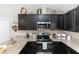 Modern kitchen with stainless steel appliances and dark cabinetry at 1326 13Th St, Orange City, FL 32763