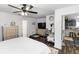 Bright main bedroom with wood floors, a ceiling fan, and doorway to the kitchen at 1326 13Th St, Orange City, FL 32763