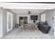 Covered patio features a dining table, barbecue grill, fan, and string lights at 1326 13Th St, Orange City, FL 32763