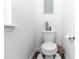 Cozy powder room featuring a toilet, artwork, and neutral decor at 1326 13Th St, Orange City, FL 32763