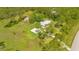 Beautiful home with a spacious driveway, detached garage, and sprawling green lawn, perfect for outdoor activities at 140 Rodeo Rd, Ormond Beach, FL 32174