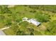 Bird's-eye view of a house with a long driveway, surrounded by greenery and trees, offering privacy and serenity at 140 Rodeo Rd, Ormond Beach, FL 32174