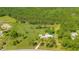Scenic aerial view of a charming home with a long driveway and lush greenery, complemented by an expansive pasture at 140 Rodeo Rd, Ormond Beach, FL 32174