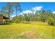 Extensive backyard with verdant grass and mature trees, providing ample space for recreation and relaxation at 140 Rodeo Rd, Ormond Beach, FL 32174