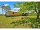Spacious backyard featuring lush greenery and mature trees, ideal for outdoor living and entertainment at 140 Rodeo Rd, Ormond Beach, FL 32174