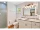 Bright bathroom with a walk-in shower, toilet, and single sink vanity with a decorative light fixture at 140 Rodeo Rd, Ormond Beach, FL 32174