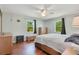 Spacious bedroom with hardwood floors, ceiling fan, two windows bringing in natural light, and classic dressers at 140 Rodeo Rd, Ormond Beach, FL 32174