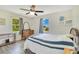 Light filled bedroom with a ceiling fan, two windows, and wood floors at 140 Rodeo Rd, Ormond Beach, FL 32174