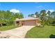 A spacious single-story home with a large two-car garage and a concrete driveway on a lush green lawn at 140 Rodeo Rd, Ormond Beach, FL 32174