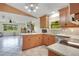 Bright, open kitchen featuring wooden cabinets and a view into the living room at 140 Rodeo Rd, Ormond Beach, FL 32174