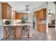 Bright kitchen featuring wood cabinets, an eat-in bar area, and stainless steel appliances with ample counter space at 140 Rodeo Rd, Ormond Beach, FL 32174