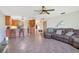 Spacious living room with an open floor plan, connected to kitchen and features comfortable seating and tile flooring at 140 Rodeo Rd, Ormond Beach, FL 32174