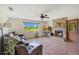 Inviting living room featuring a stone fireplace, comfortable seating, and tile floors, and a large window view at 140 Rodeo Rd, Ormond Beach, FL 32174