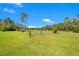 Open field with a gated fence, providing a secure and spacious area for livestock or other uses at 140 Rodeo Rd, Ormond Beach, FL 32174
