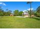 Wide shot of a home with a large lawn, showcasing its rural charm and spacious outdoor area at 140 Rodeo Rd, Ormond Beach, FL 32174