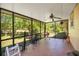 Serene screened porch showcasing tile floors, a ceiling fan, and panoramic views of the backyard and green space at 140 Rodeo Rd, Ormond Beach, FL 32174