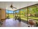 Relaxing screened porch featuring tile floors, a ceiling fan, and views of the backyard and beyond at 140 Rodeo Rd, Ormond Beach, FL 32174