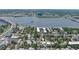 Captivating aerial view showing the neighborhood, nearby lake, and the home's location amidst lush greenery and urban convenience at 145 S Peninsula Dr, Daytona Beach, FL 32118