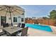 Private backyard pool area with a table and chairs, perfect for outdoor entertaining and relaxation at 145 S Peninsula Dr, Daytona Beach, FL 32118