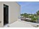 Inviting balcony with neighborhood views, showcasing mature trees and sunny skies at 145 S Peninsula Dr, Daytona Beach, FL 32118