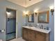 Contemporary bathroom with double sinks, a marble countertop and modern fixtures at 145 S Peninsula Dr, Daytona Beach, FL 32118
